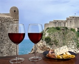 Two glasses of wine with view of Fortress Lovrijenac from Dubrovnik city walls